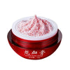 A red cosmetic jar labeled 'DRAGON BLOOD CREAM' with white Chinese characters, shown open with a textured red-and-white cream product piled on top, against a plain white background.