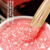 Close-up of a pink gel-like substance with a gold tool, branded 'Precious Dragon'.