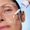 Skincare product being applied to a person's face with text highlighting skin brightening and tone evening effects.