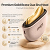 A premium solid brass gua sha head massage tool shown on a beige background with feature callouts. The device has a metallic gold interior and a pale pink exterior with black trim.