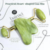 Green heart-shaped Gua Sha tool with gold accents on a white background, featuring the brand 'baimei'.