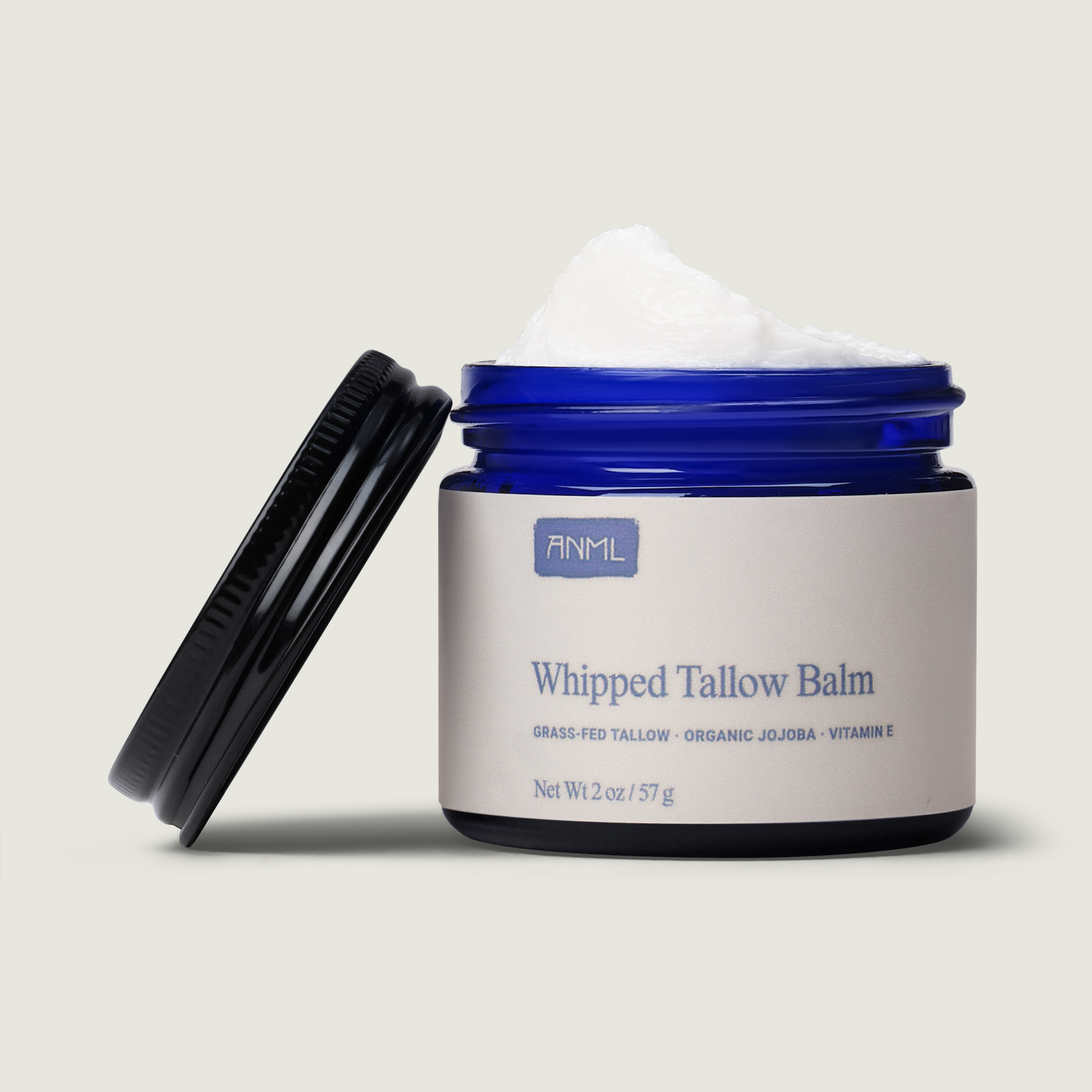 Whipped tallow balm jar with visible brand name on a neutral background