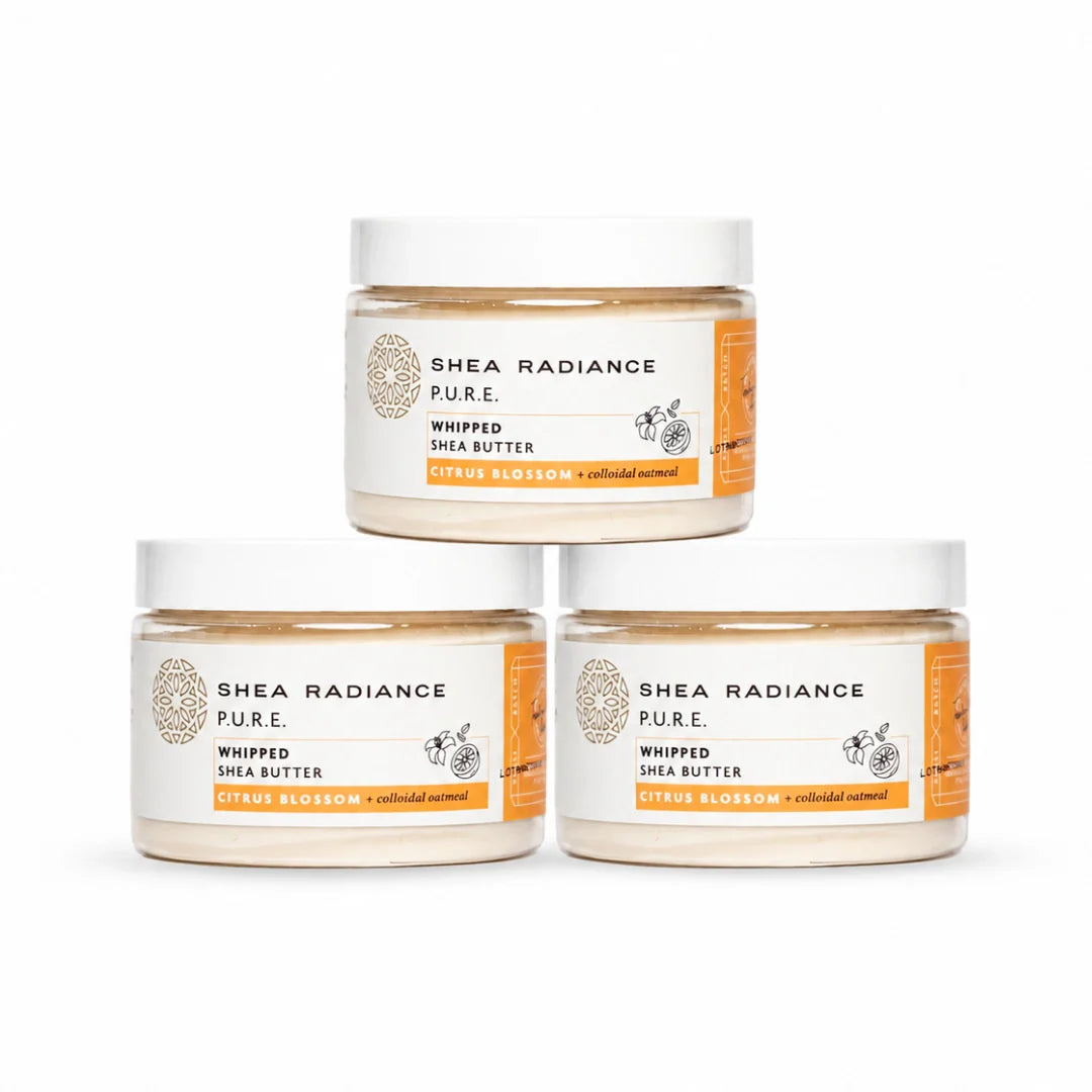Three jars of Shea Radiance Pure Whipped Shea Butter in a pyramid arrangement on a white background. The labels feature orange accents and text for 'Citrus Blossom + Almond Butter'.