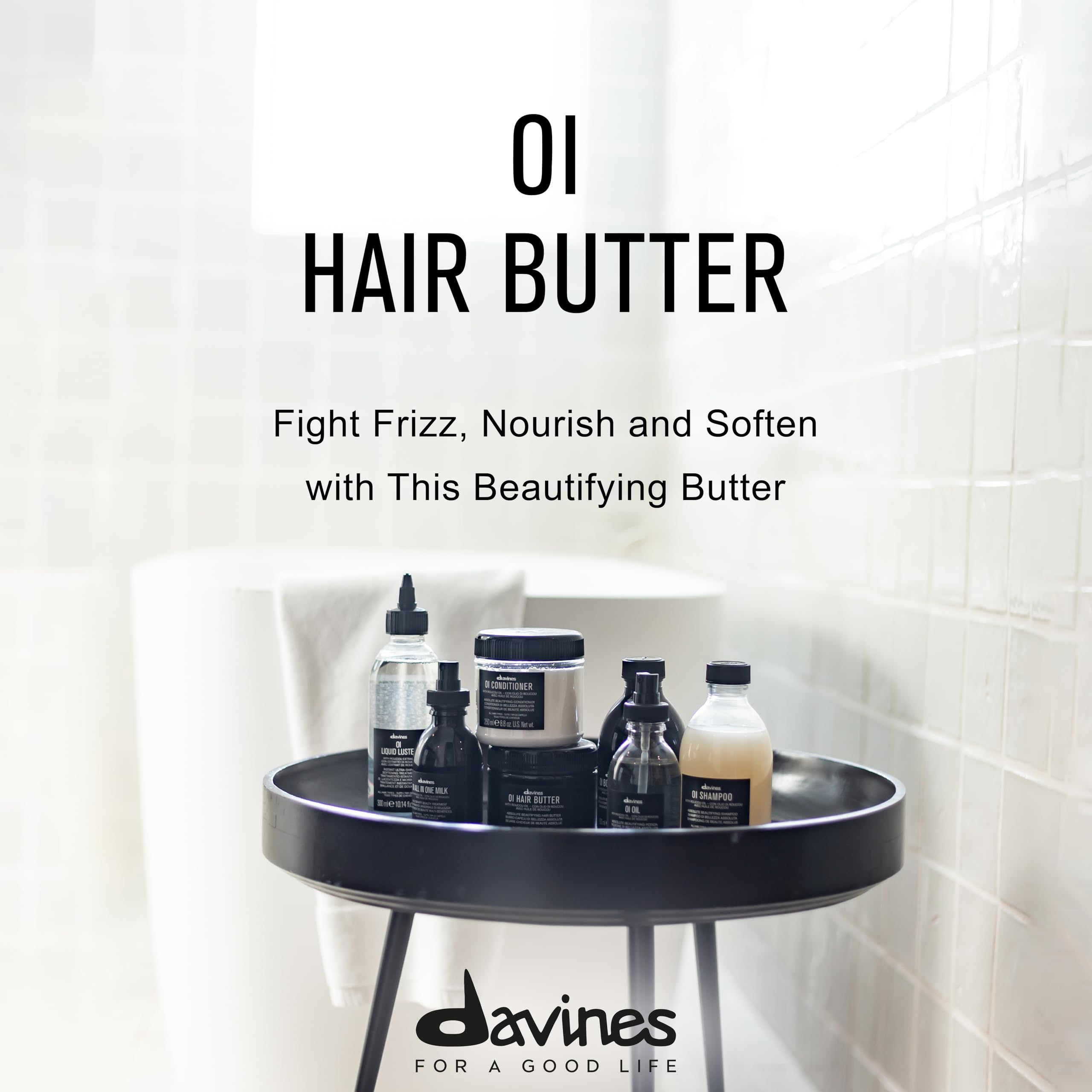 Collection of Davines hair care products on a round black tray with promotional text.