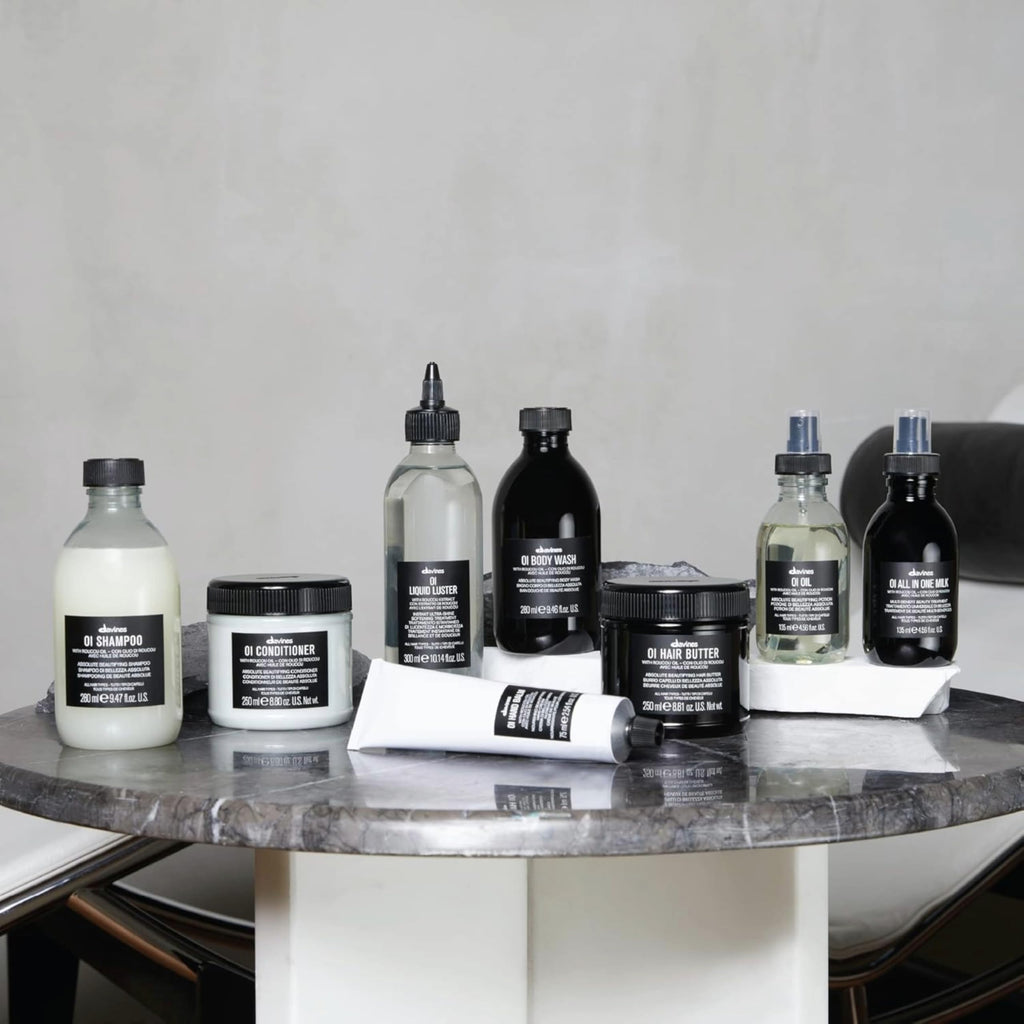 Collection of Aesop skincare and haircare products on a marble surface.