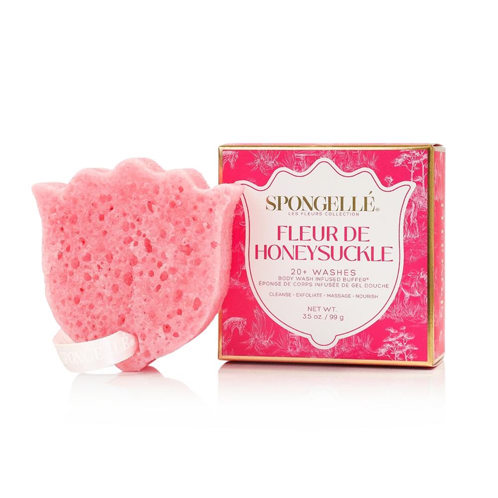 A pink flower-shaped sponge bar next to its pink packaging box labeled Spongellée Fleur de Honeysuckle, on a clean white background.