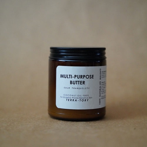 Jar of multi-purpose butter with a label on a brown background