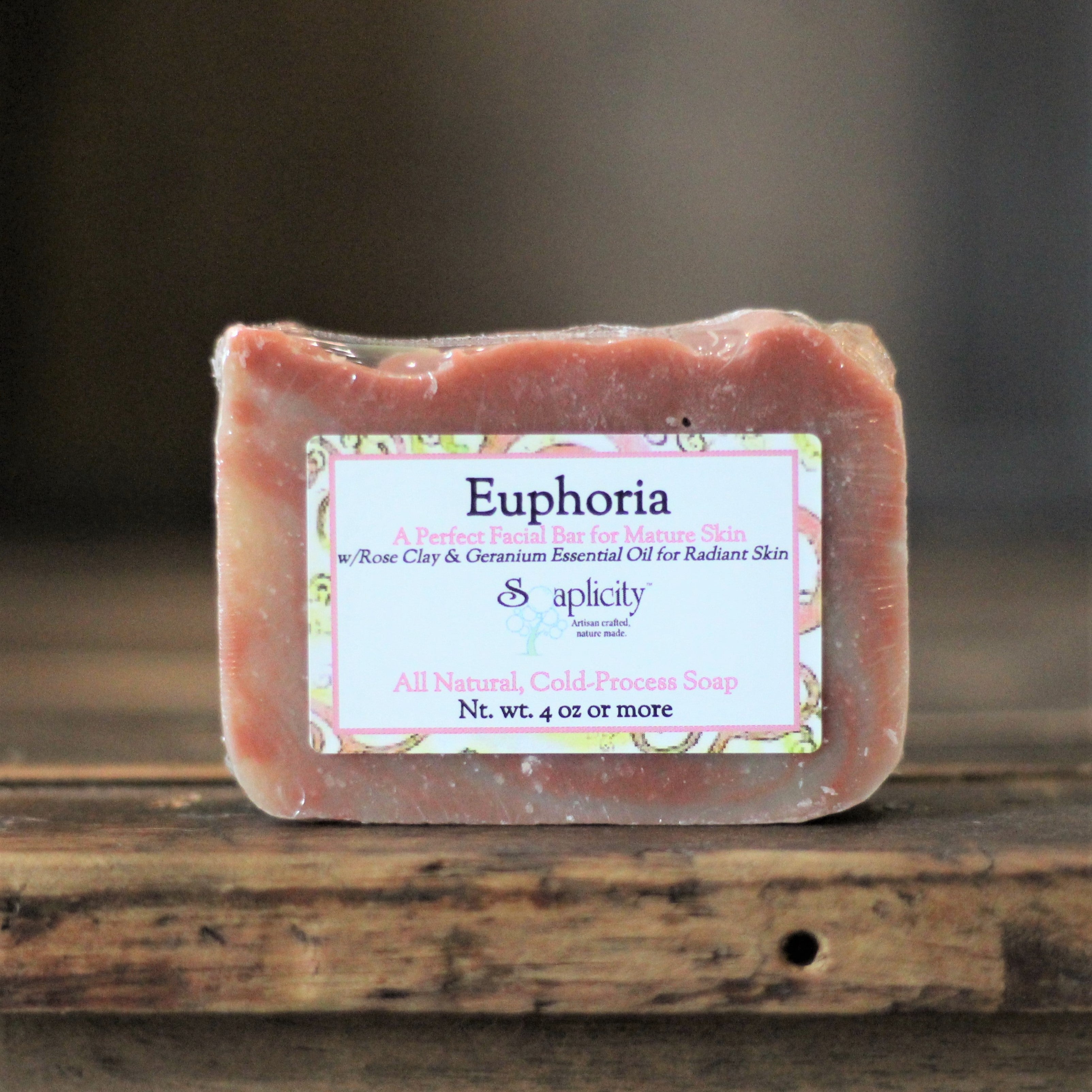 Bar of soap with a label on a wooden surface