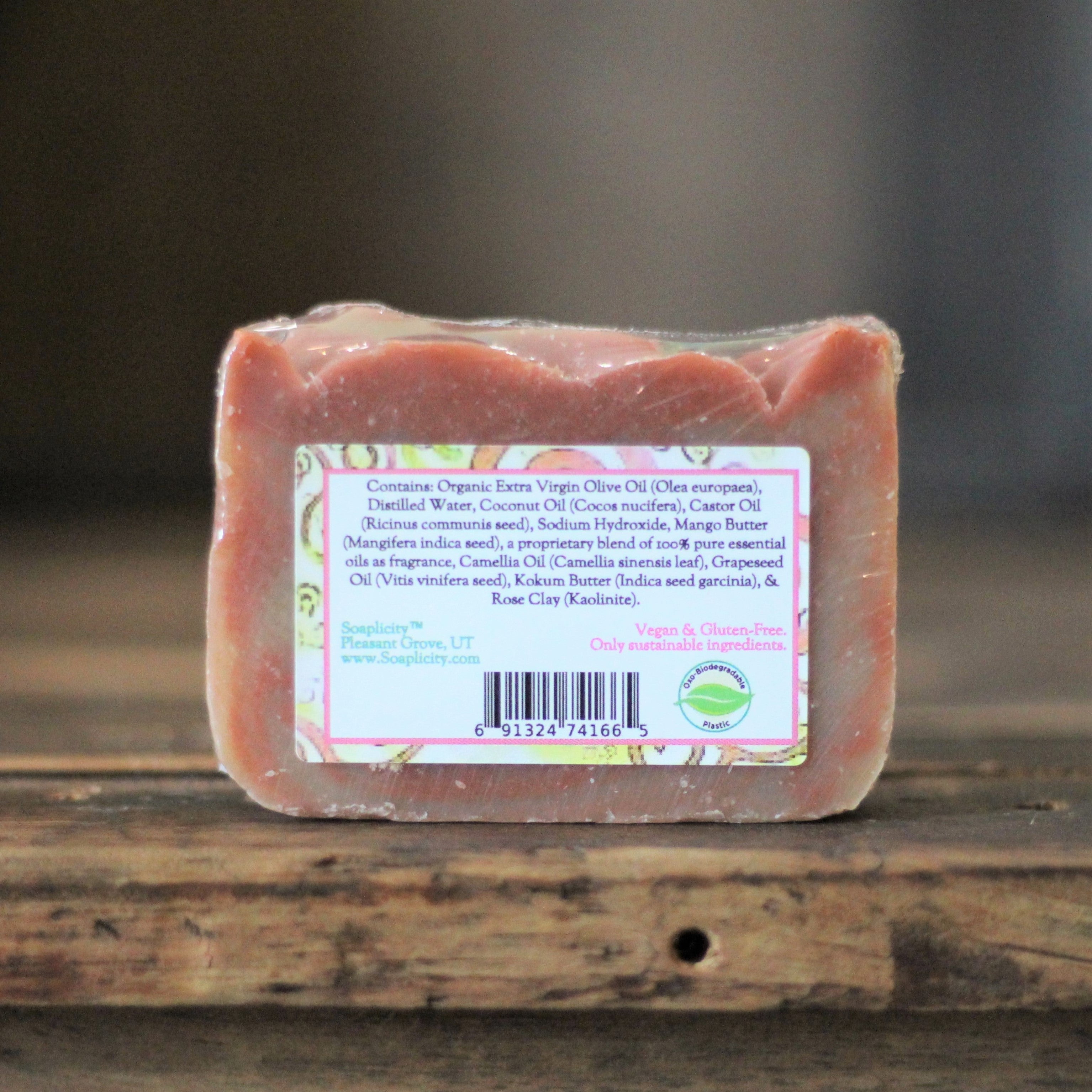 Bar of soap with a label on a wooden surface