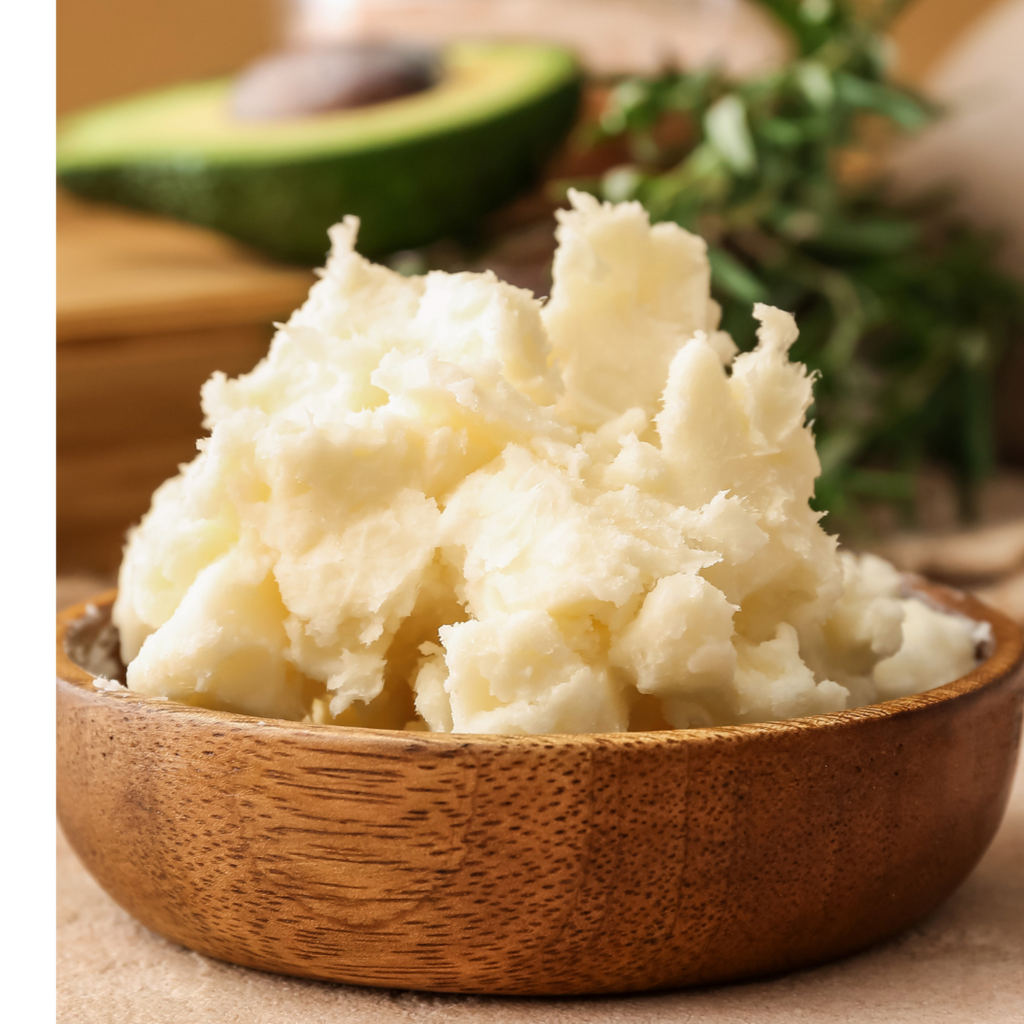Mashed potatoes in a wooden bowl with an avocado in the background