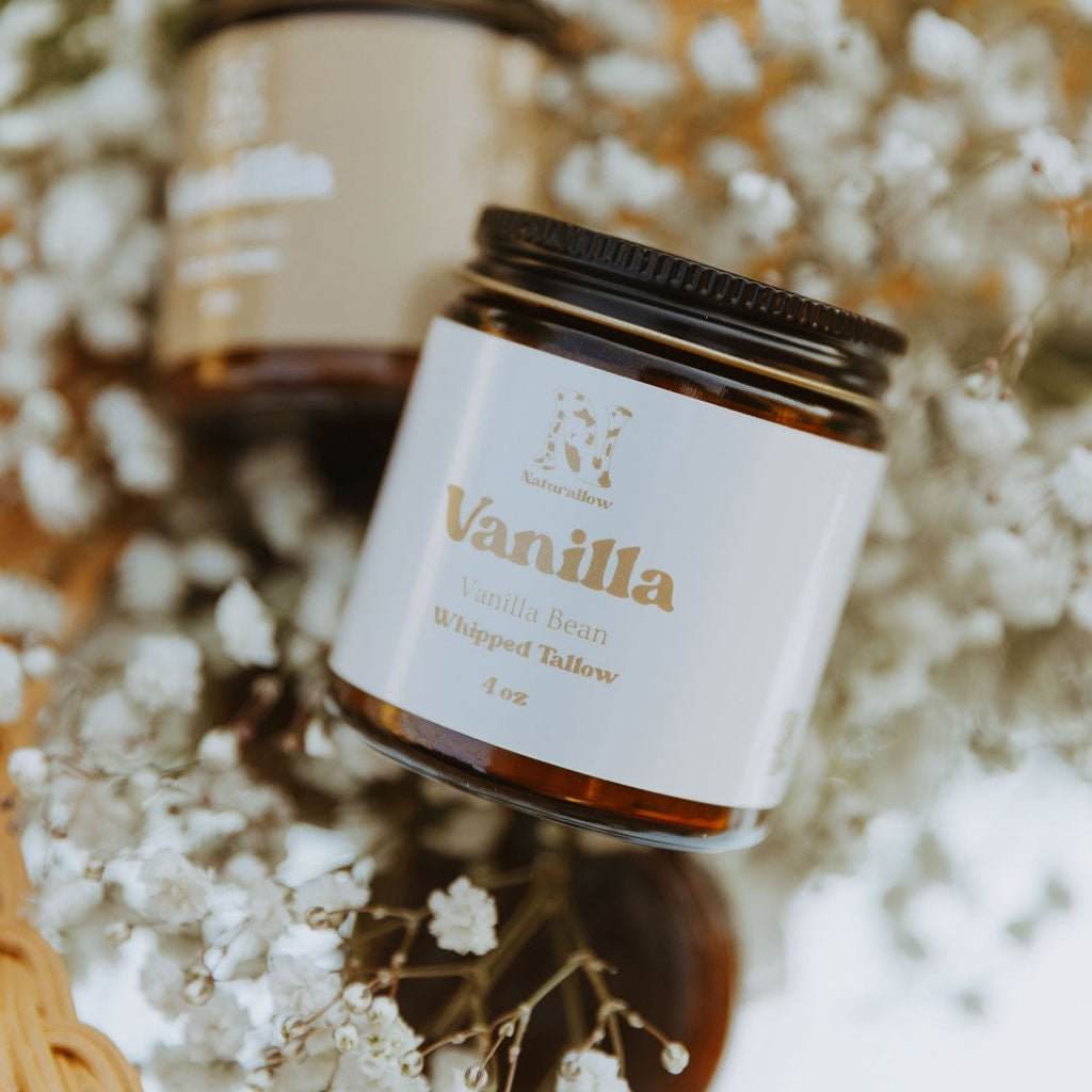 Jar of Vanilla Bean Whipped Tallow with a white label on a floral background