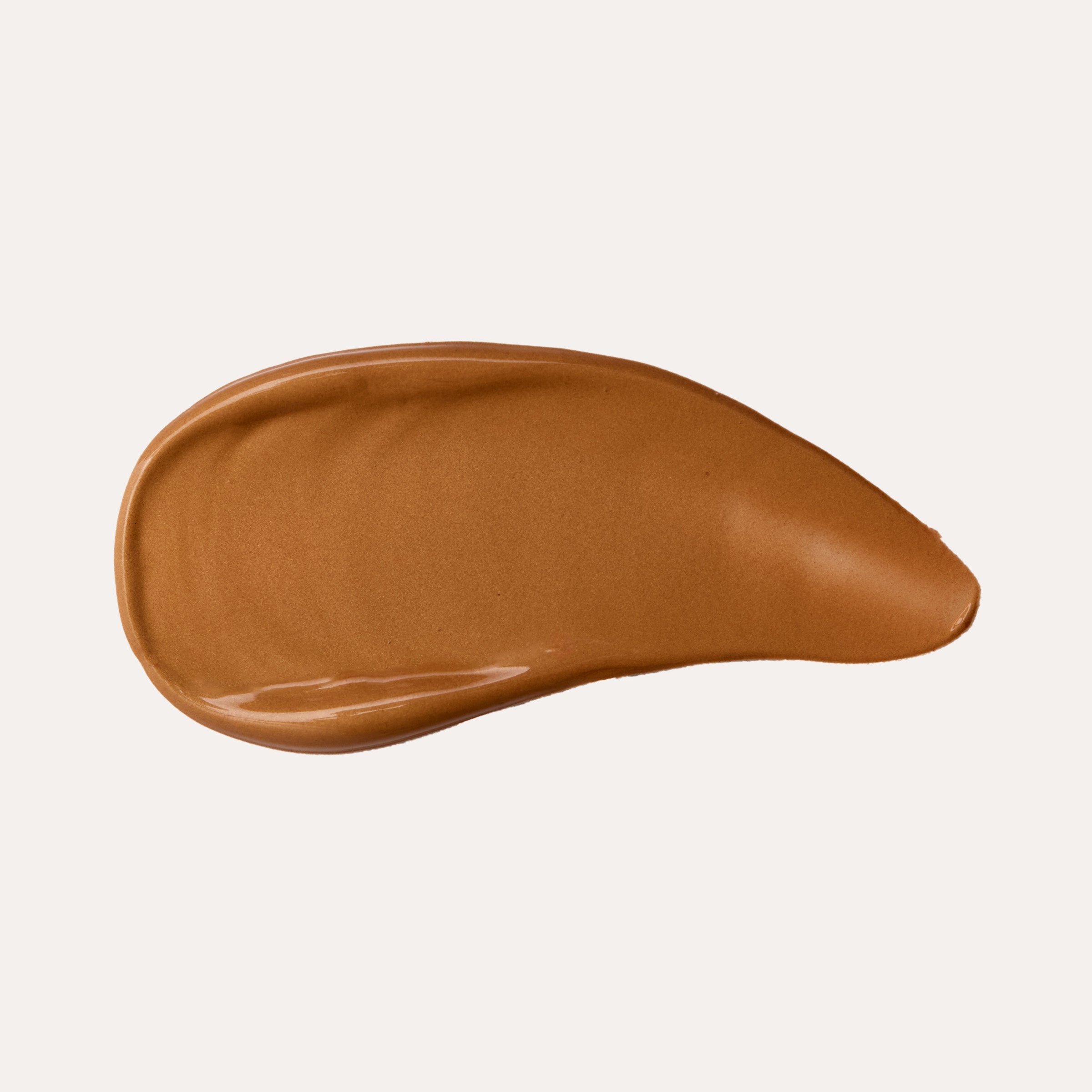 Brown cosmetic swatch on a beige background