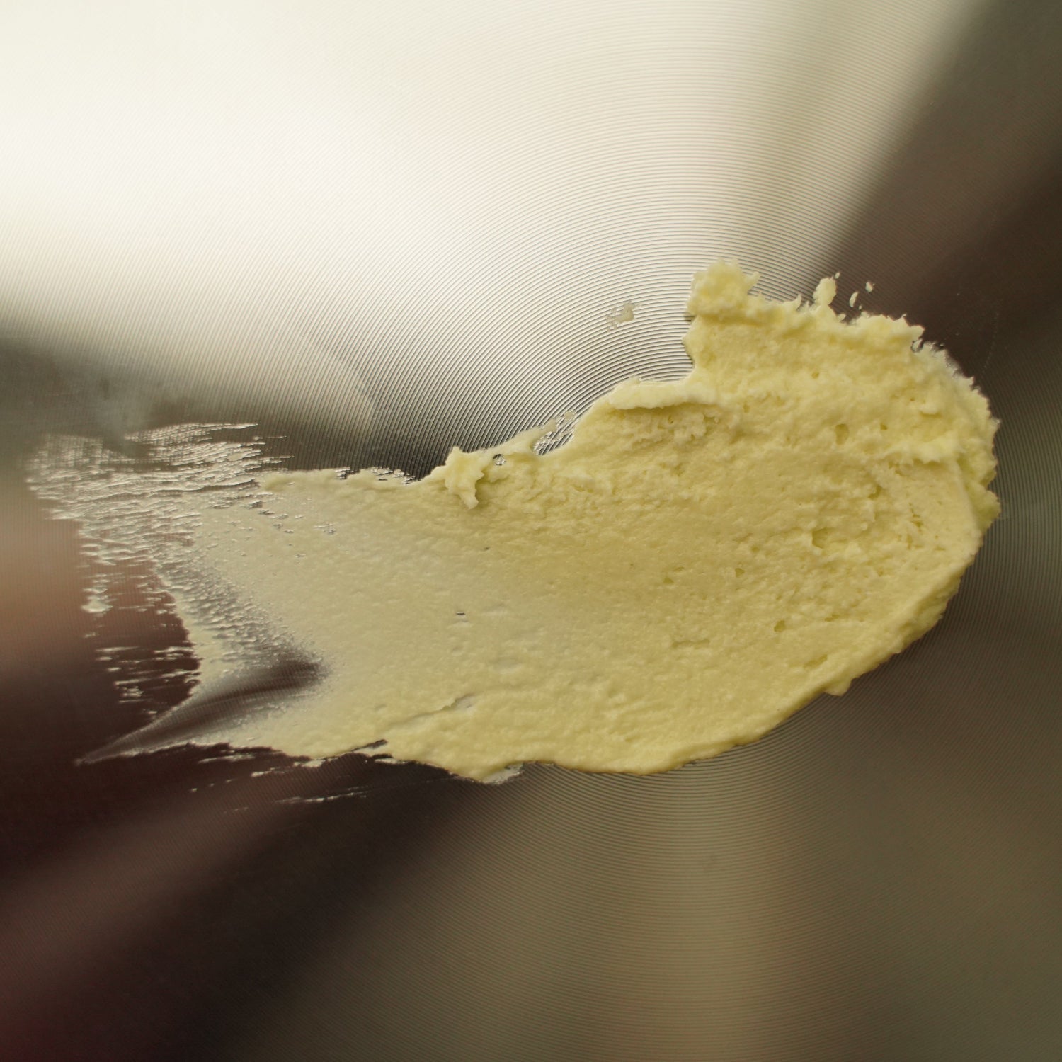 Close-up of a yellowish substance on a metallic surface