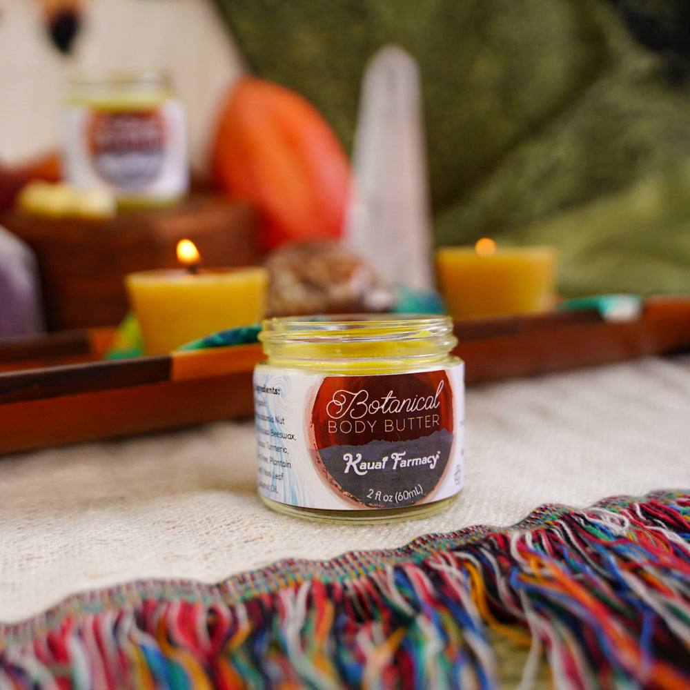 Jar of Botanical Body Butter with candles and pumpkins in the background