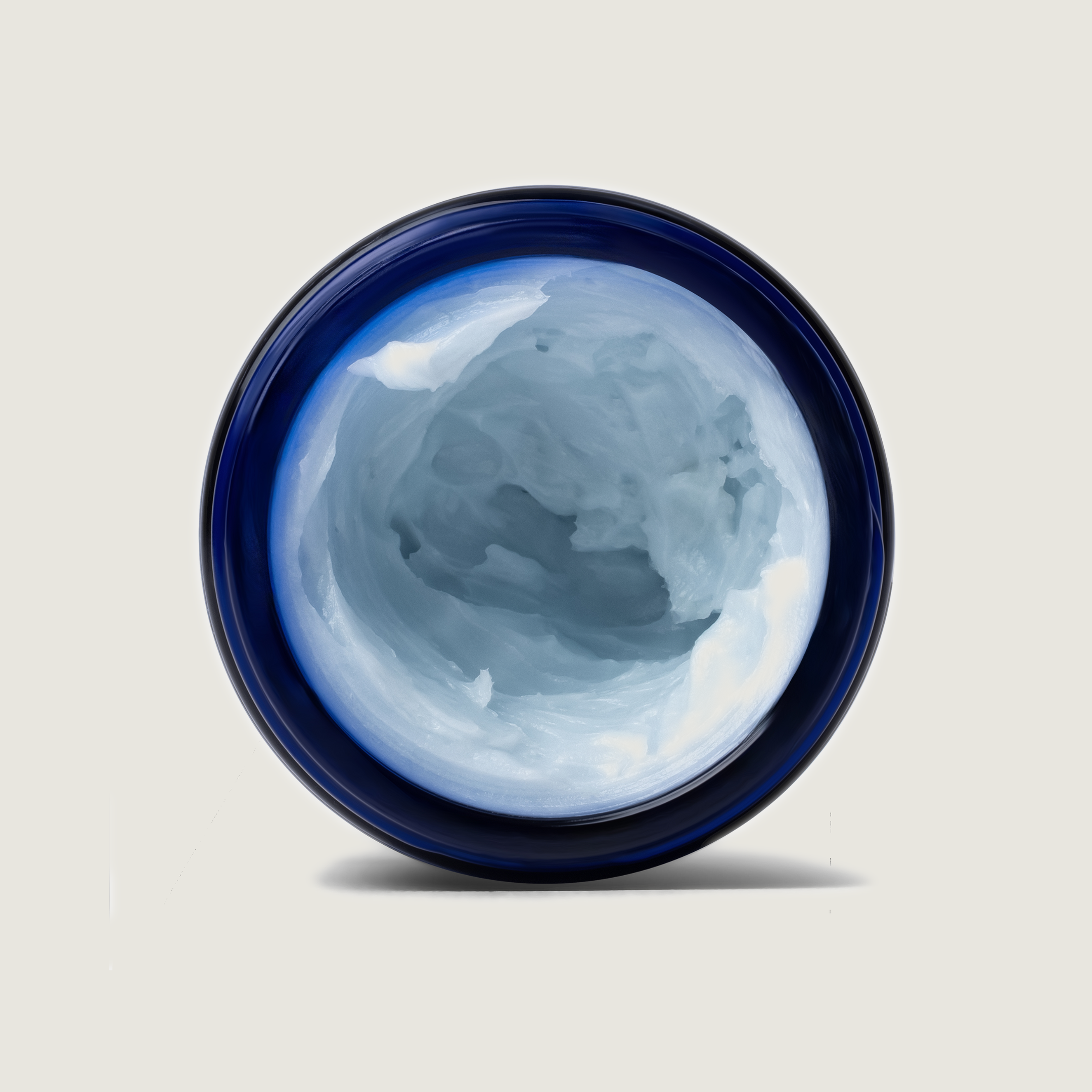 Blue ceramic bowl with a textured interior on a light gray background