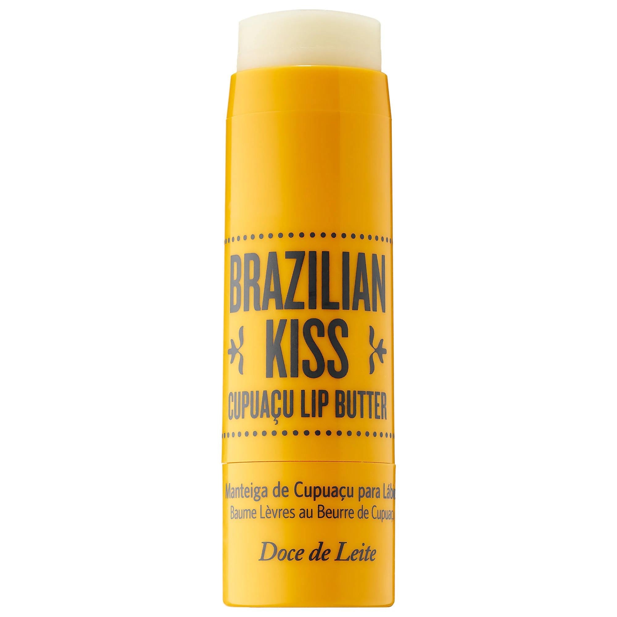 A yellow tube of Brazilian Kiss Cupacu Lip Butter by Doce de Leite, featuring a white cap, on a solid white background.