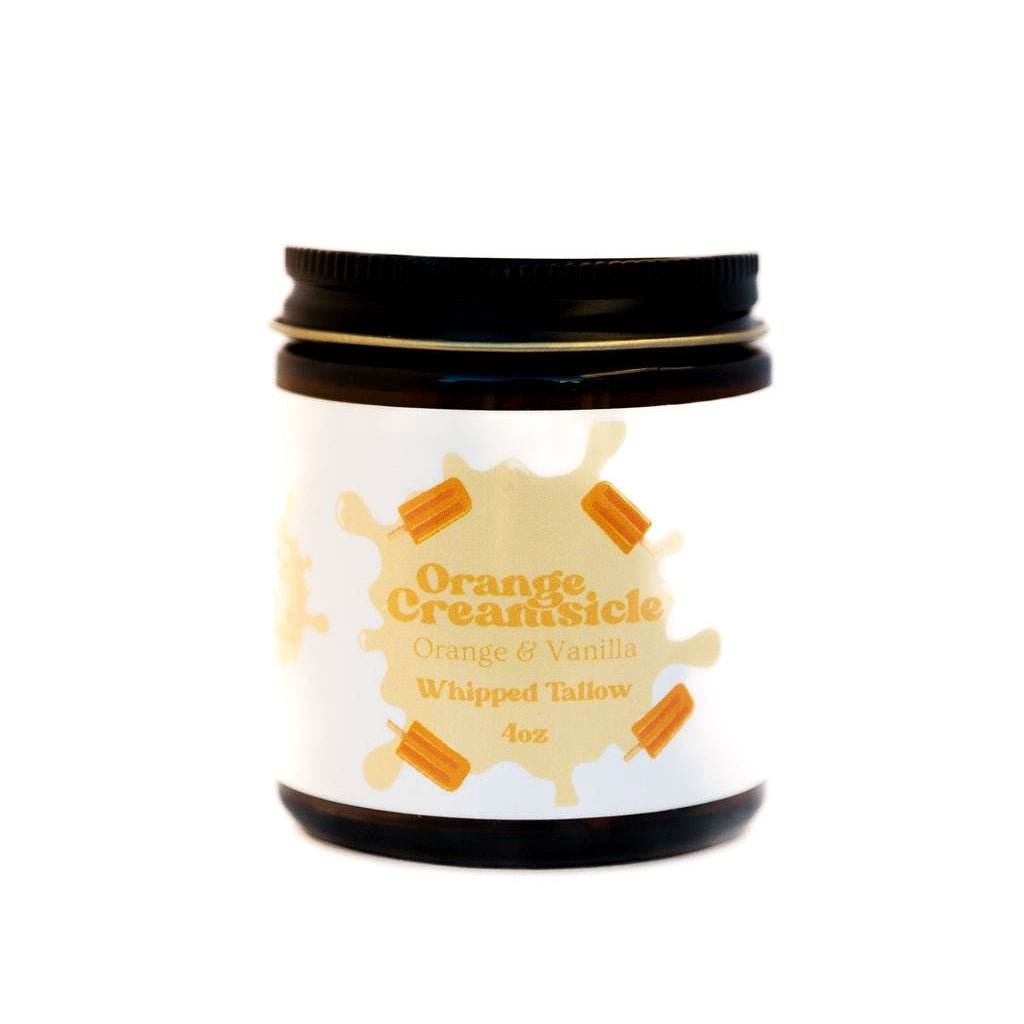 Jar of Orange Creamsicle whipped tallow on a white background