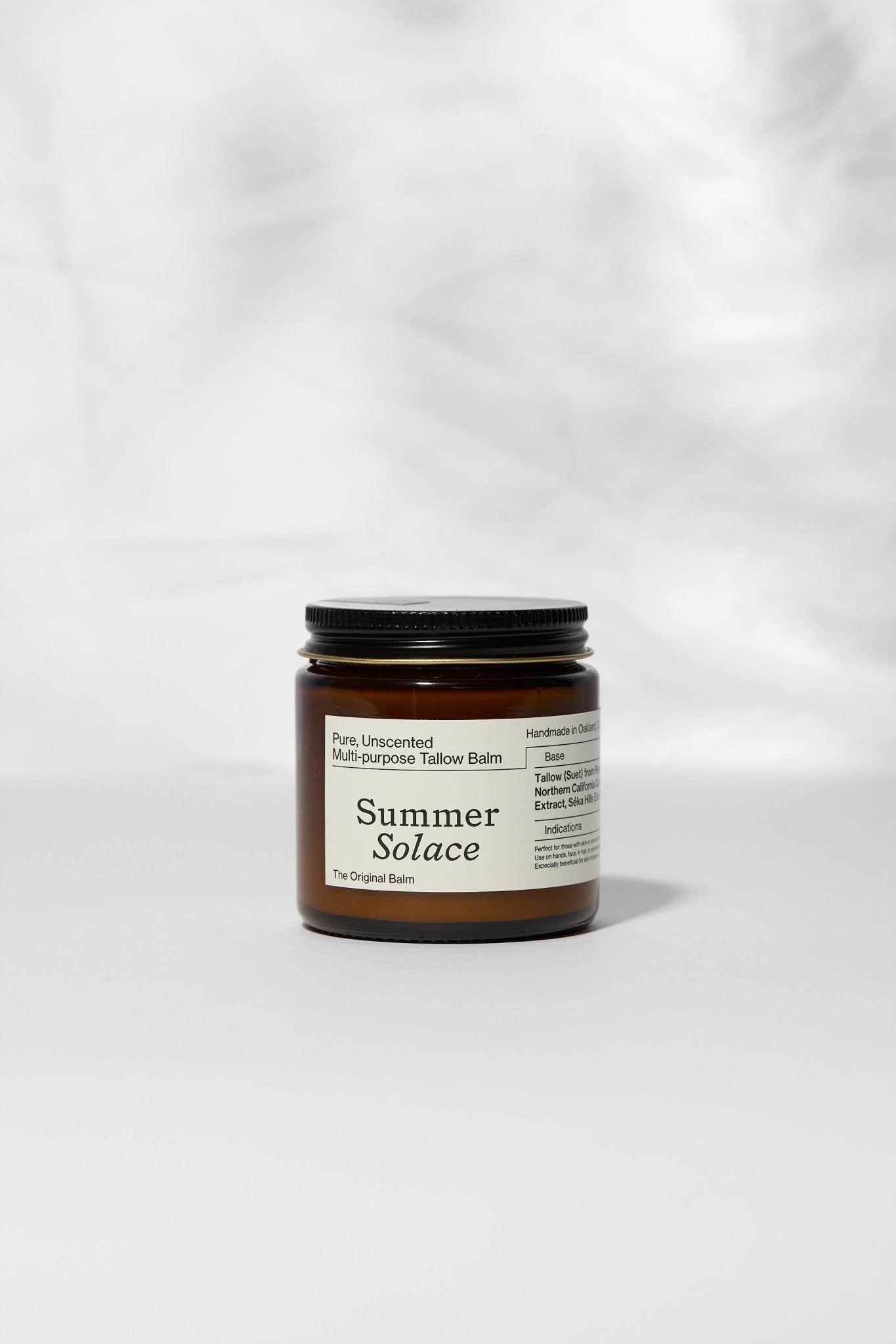 Jar of 'Summer Solace' balm on a white background