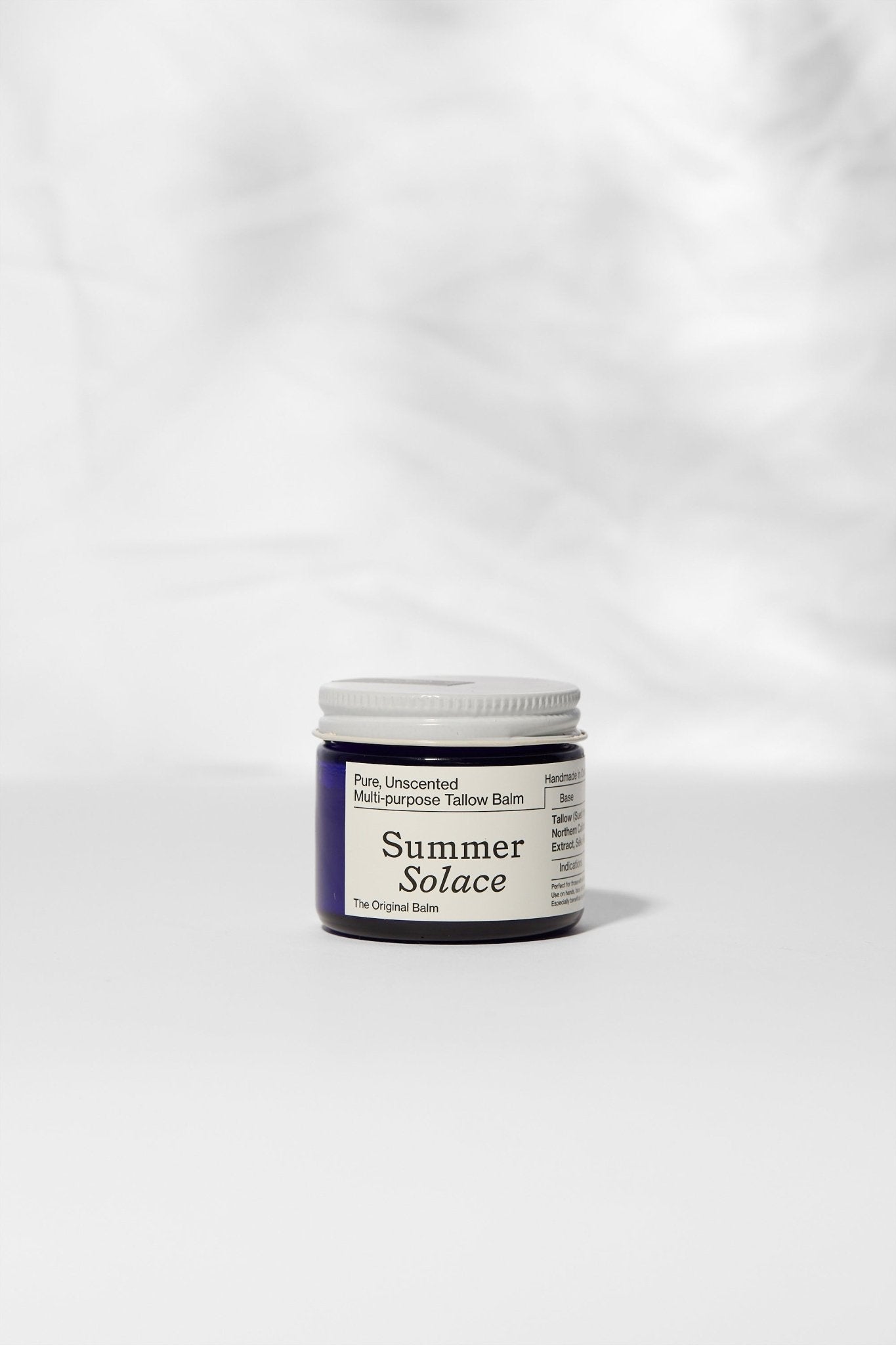 Jar of 'Summer Solace' balm on a white background